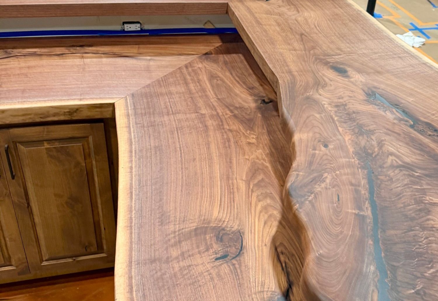 Live edge walnut bar top with black resin filling the natural checks